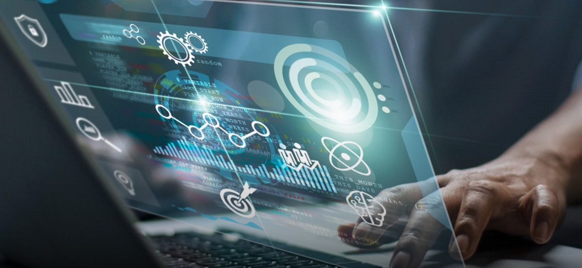 A stylized view through a transparent laptop computer screen at digital shapes and patterns, behind which are a hand interacting with the laptop keyboard