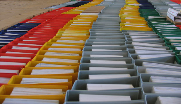 Photograph of endless binders of paper reports